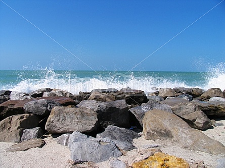 ocean crashes over rocks